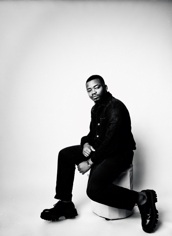 Black and white seated studio portrait
