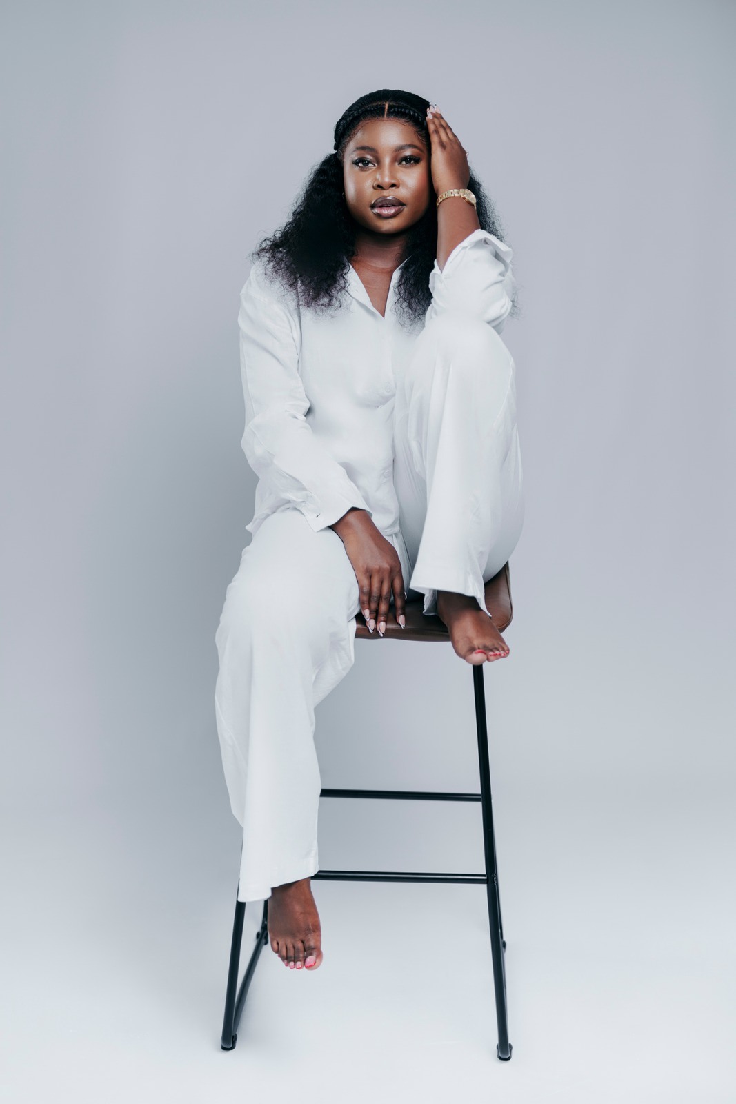 Studio portrait in a white suit