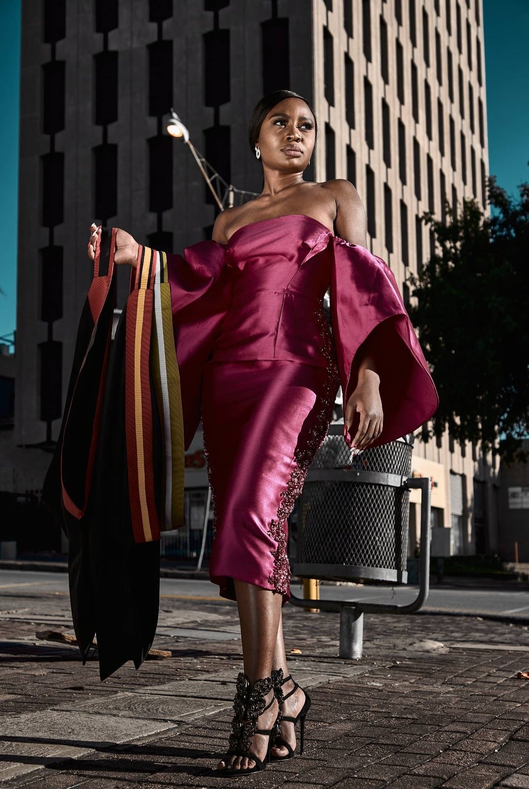 Outdoor fashion portrait in a burgundy dress